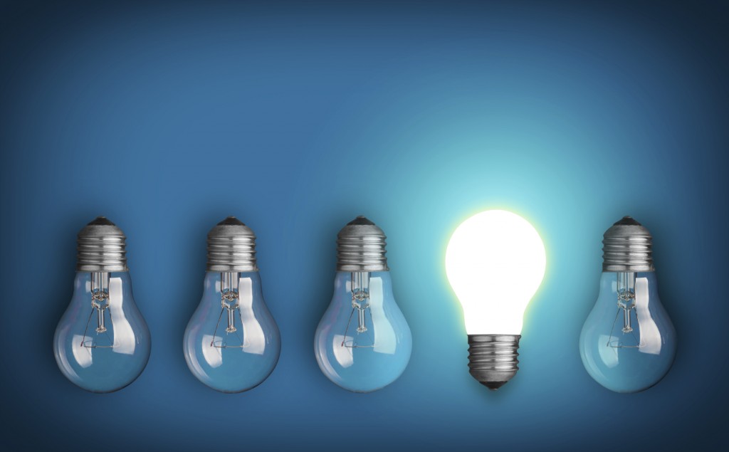 Idea concept with row of light bulbs and glowing bulb